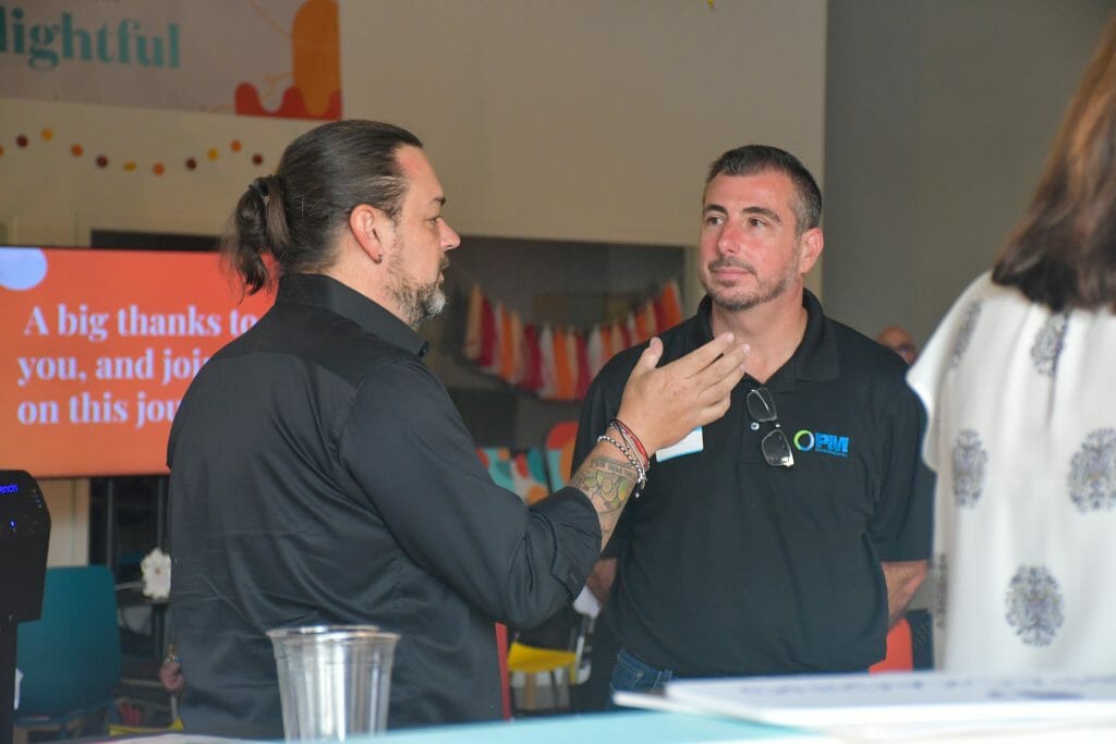 Dwight Zahringer, founder of Trademark Productions now Perfect Afternoon, talking to one of our partners at Southeastern Michigan Society for Healthcare Engineering.