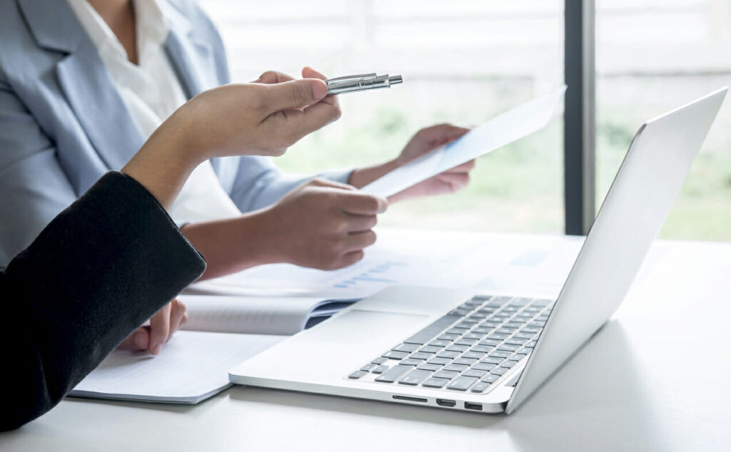 A team work on a website using a laptop