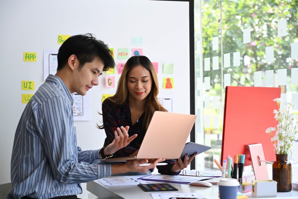 User experience designers team are brainstorming and planning sketch, prototype, framework, layout app design project at office.